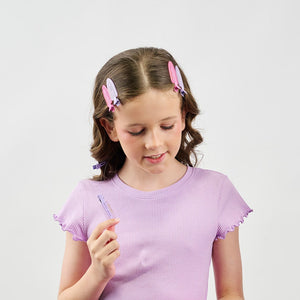Girl with pink and purple hair clips on a white background