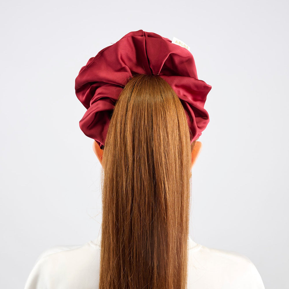 Red scrunchie on a white background
