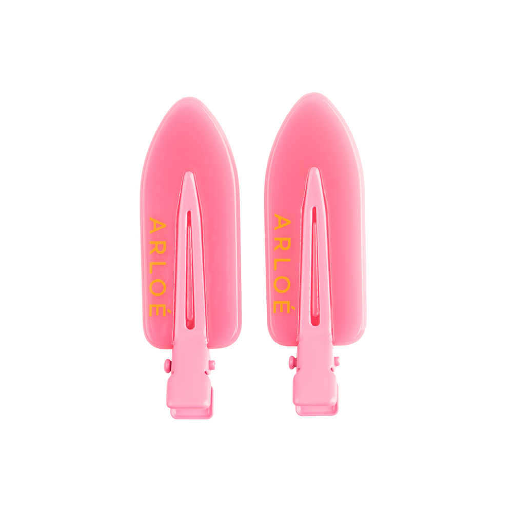 Two pink hair clips with ARLOE branding on a white background