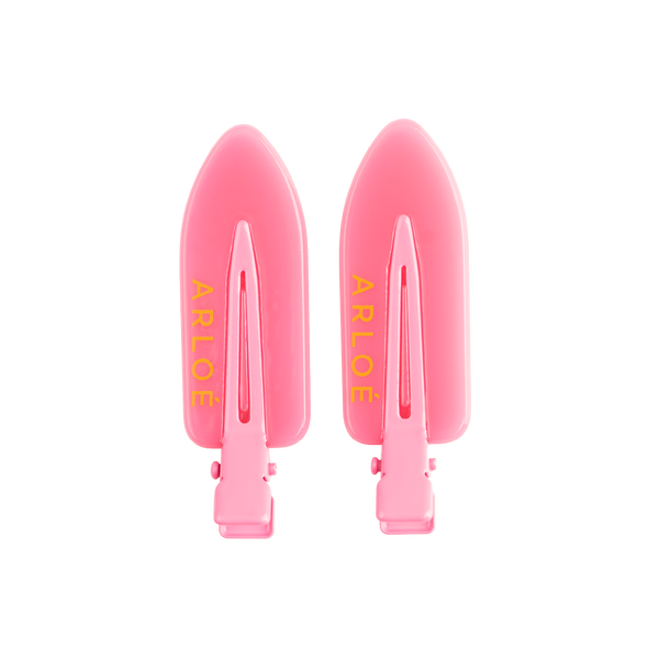 Two pink hair clips with ARLOE branding on a white background
