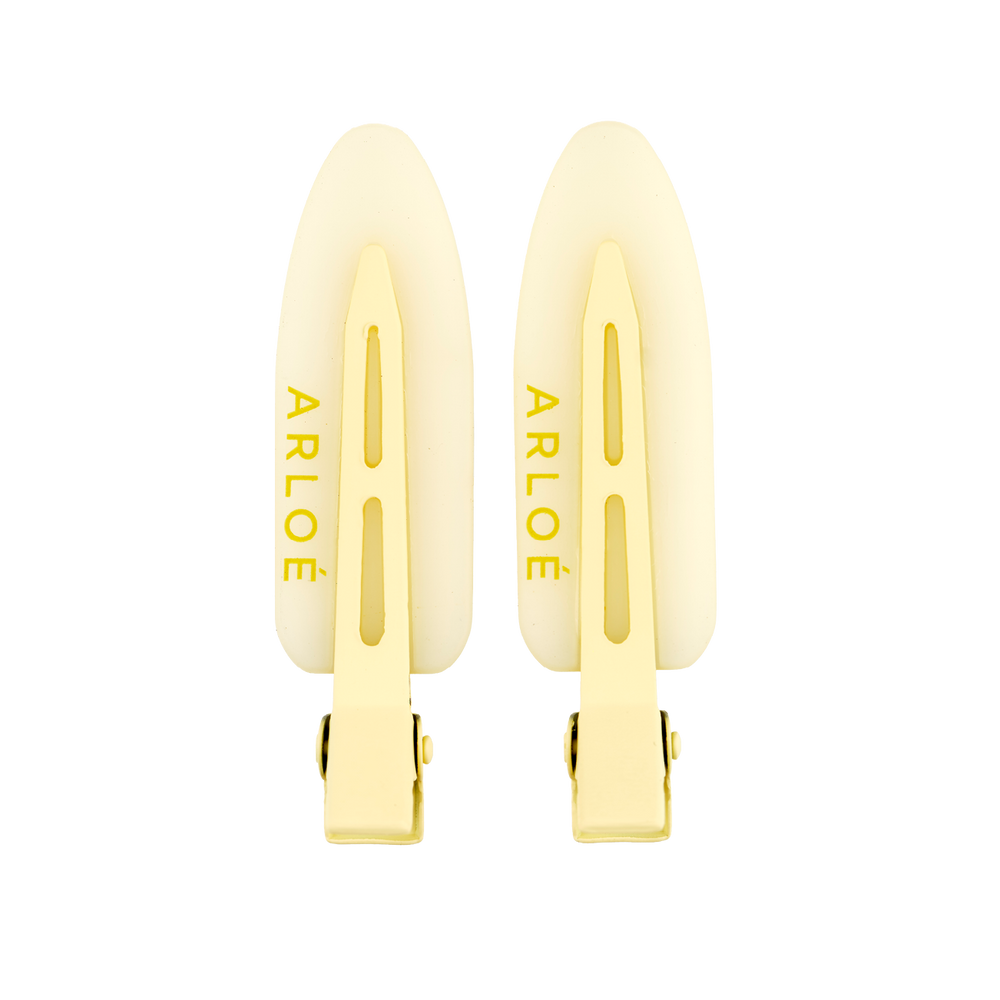Two yellow hair clips with ARLOE branding on a white background
