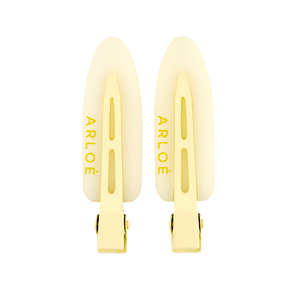 Two yellow hair clips with ARLOE branding on a white background
