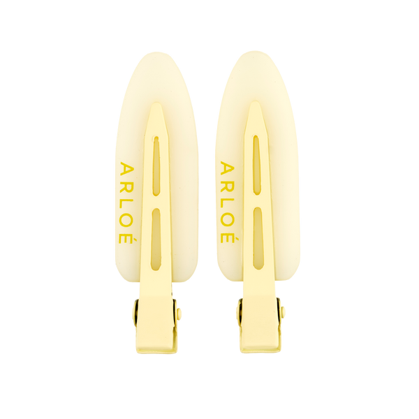 Two yellow hair clips with ARLOE branding on a white background
