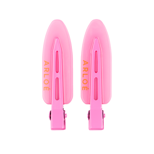 Two pink hair clips with 'ARLOE' branding on a white background