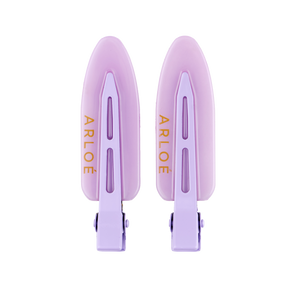 Two purple hair clips with ARLOE branding on a white background