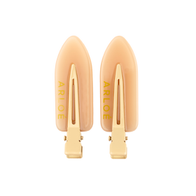 Pair of gold hair clips with 'ARLOE' branding on a white background