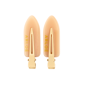 Pair of gold hair clips with 'ARLOE' branding on a white background
