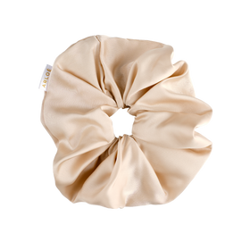 Beige scrunchie with a visible brand tag on a white background