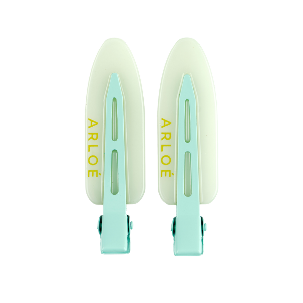 Two mint coloured hair clips with 'ARLOE' branding on a white background