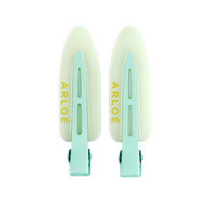 Two mint coloured hair clips with 'ARLOE' branding on a white background