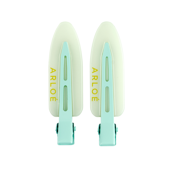 Two mint coloured hair clips with 'ARLOE' branding on a white background